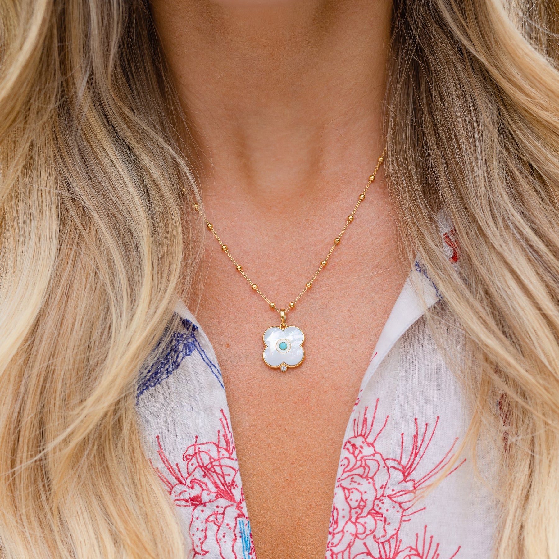 Gold chain necklace with dipped mother of pearl and turquoise Evil Eye charm.