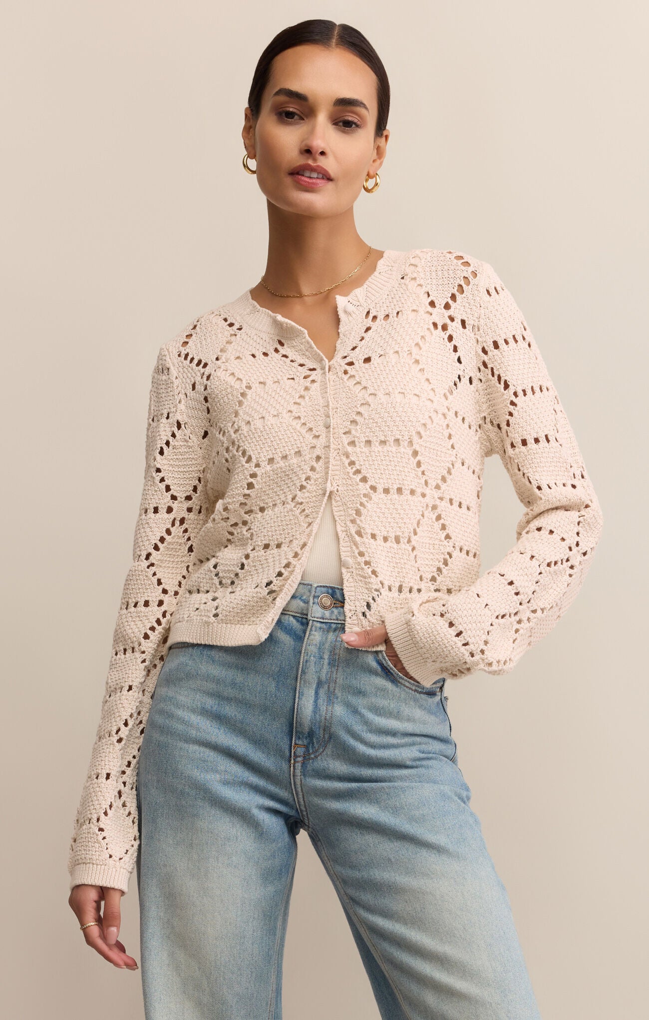 The Rosalyn Sweater Cardigan has a crystal pink hue and delicate eyelet details with a touch of sparkle.